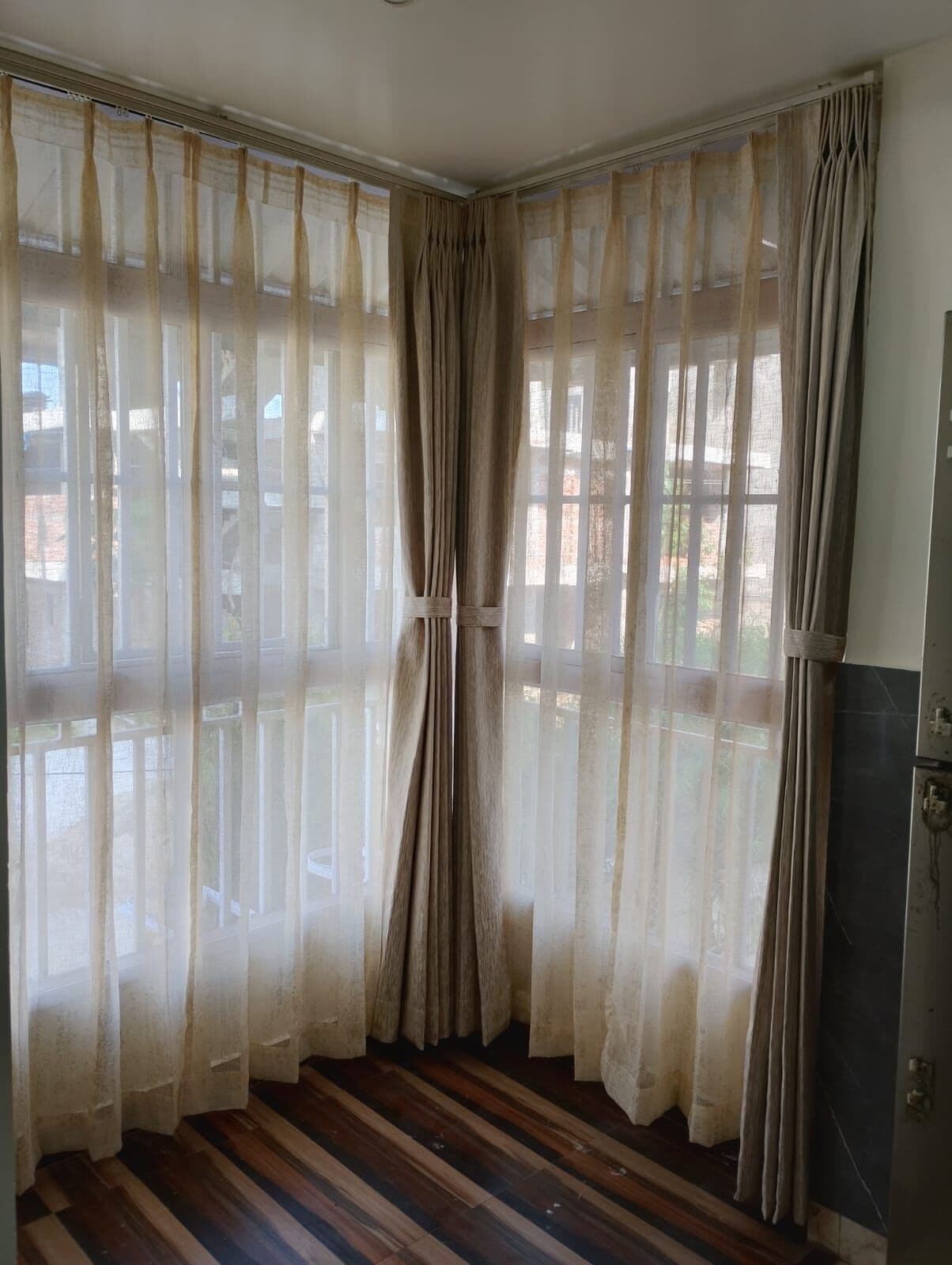 Sheers and drapes around a bay window